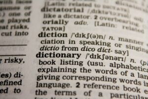 Detailed close-up view of a dictionary page highlighting the word 'dictionary' and its definition.